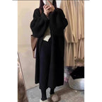 A long khaki knitted cardigan that’s soft, warm, and comfortably loose for all body types. Perfect for work and everyday fall outfits, adding a touch of effortless elegance to any look.