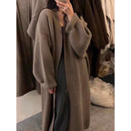 A long khaki knitted cardigan that’s soft, warm, and comfortably loose for all body types. Perfect for work and everyday fall outfits, adding a touch of effortless elegance to any look.